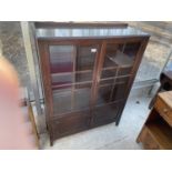 A 19TH CENTURY STYLE TWO DOOR GLAZED BOOKCASE WITH PANELLED DOORS TO THE BASE, 36" WIDE