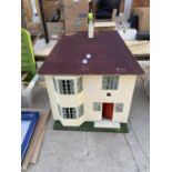 A VINTAGE WOODEN DOLLS HOUSE