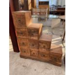 A HARDWOOD STEPPED CHEST OF TEN DRAWERS, 30" WIDE
