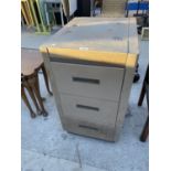 A METAL THREE DRAWER FILING CABINET