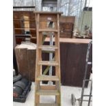 A VINTAGE 6 RUNG WOODEN STEP LADDER AND A FURTHER 6 RUNG ALUMINIUM STEP LADDER