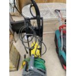 A KARCHER 411A ELECTRIC PRESSURE WASHER AND A REEL OF HOSE PIPE