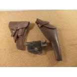 A BLACK LEATHER WALTHER PP BELT HOLSTER AND TWO FURTHER BROWN LEATHER HOLSTERS (3)