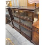 A GLOBE WERNIKE BOOKCASE ENCLOSING FOUR SMALL DOORS, TWO LARGE DOORS AND TWO DRAWERS TO THE BASE,