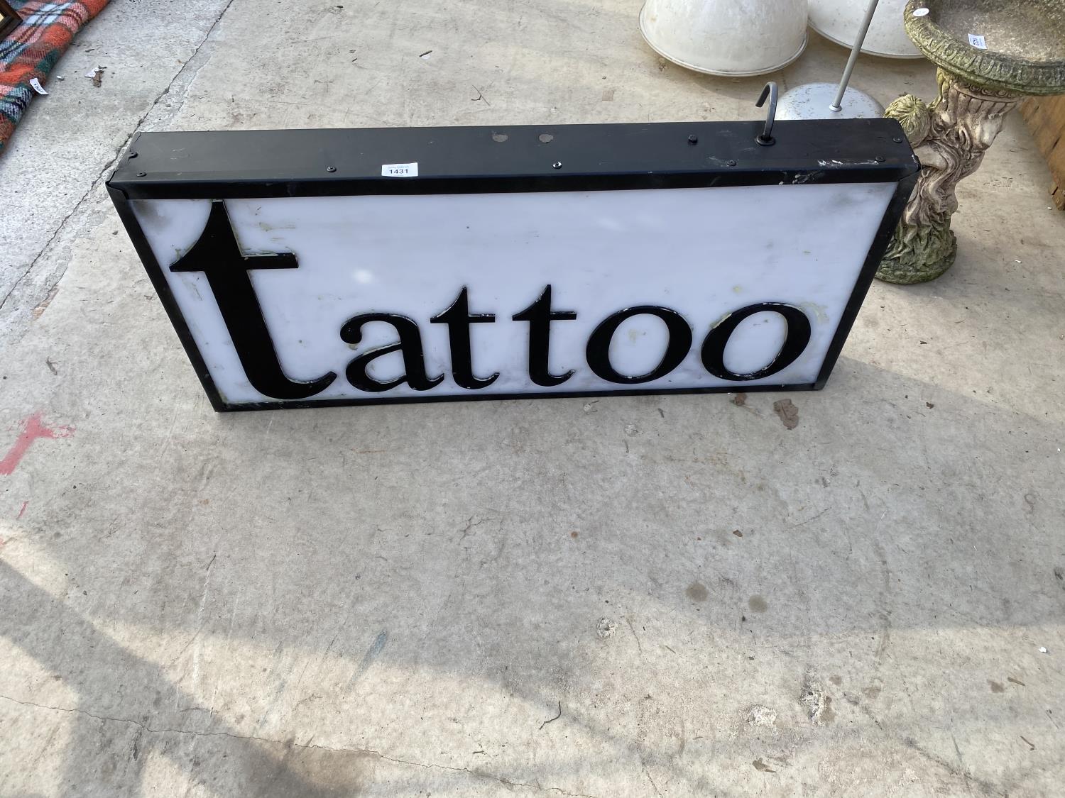 A LARGE ILLUMINATED 'TATTOO' SIGN