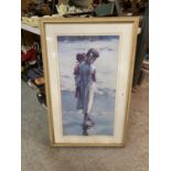 A LARGE FRAMED PRINT OF A MOTHER AND CHILD ON THE SHORELINE (BACK A/F)