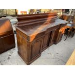 A VICTORIAN MAHOGANY INVERTED BREAKFRONT SIDEBOARD WITH RAISED BACK, THREE FRIEZE DRAWERS AND FOUR