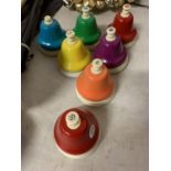 A SET OF RAINBOW MUSICAL HAND BELLS