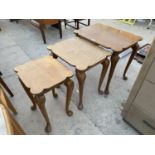 A NEST OF THREE WALNUT TABLES ON CABRIOLE LEGS