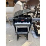 A SMALL WOODEN GRAND PIANO AND STOOL