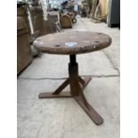 A VINTAGE INDUSTRIAL STYLE WOODEN STOOL WITH CAST BASE