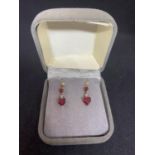 A PAIR OF 9 CARAT GOLD AND GARNET EARRINGS IN A PRESENTATION BOX