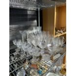 A LARGE ASSORTMENT OF GLASS WARE TO INCLUDE WINE GLASSES AND BOWLS ETC