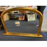 A LARGE GILT FRAMED OVERMANTEL MIRROR