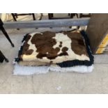 A COLLECTION OF FIVE RUGS TO INCLUDE A COW HIDE PRINT ETC