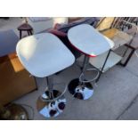 A PAIR OF RETRO RED AND WHITE KITCHEN BAR STOOLS ON CHROMIUM PLATED BASES