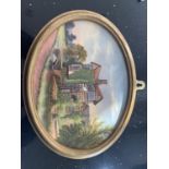 A FRAMED OVAL CERAMIC PLAQUE OF LITTLE MORETON HALL BY JOHN THORLEY