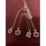 FOUR SILVER NECKLACES MARKED 925 WITH PENDANTS IN A ROSE GOLD COLOUR