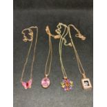 FOUR SILVER NECKLACES MARKED 925 WITH PENDANTS TO INCLUDE A BUTTERFLY, FLOWER, ETC ALL IN A ROSE