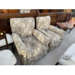 A PAIR OF EDWARDIAN SPRUNG AND UPHOSLTERED EASY CHAIRS