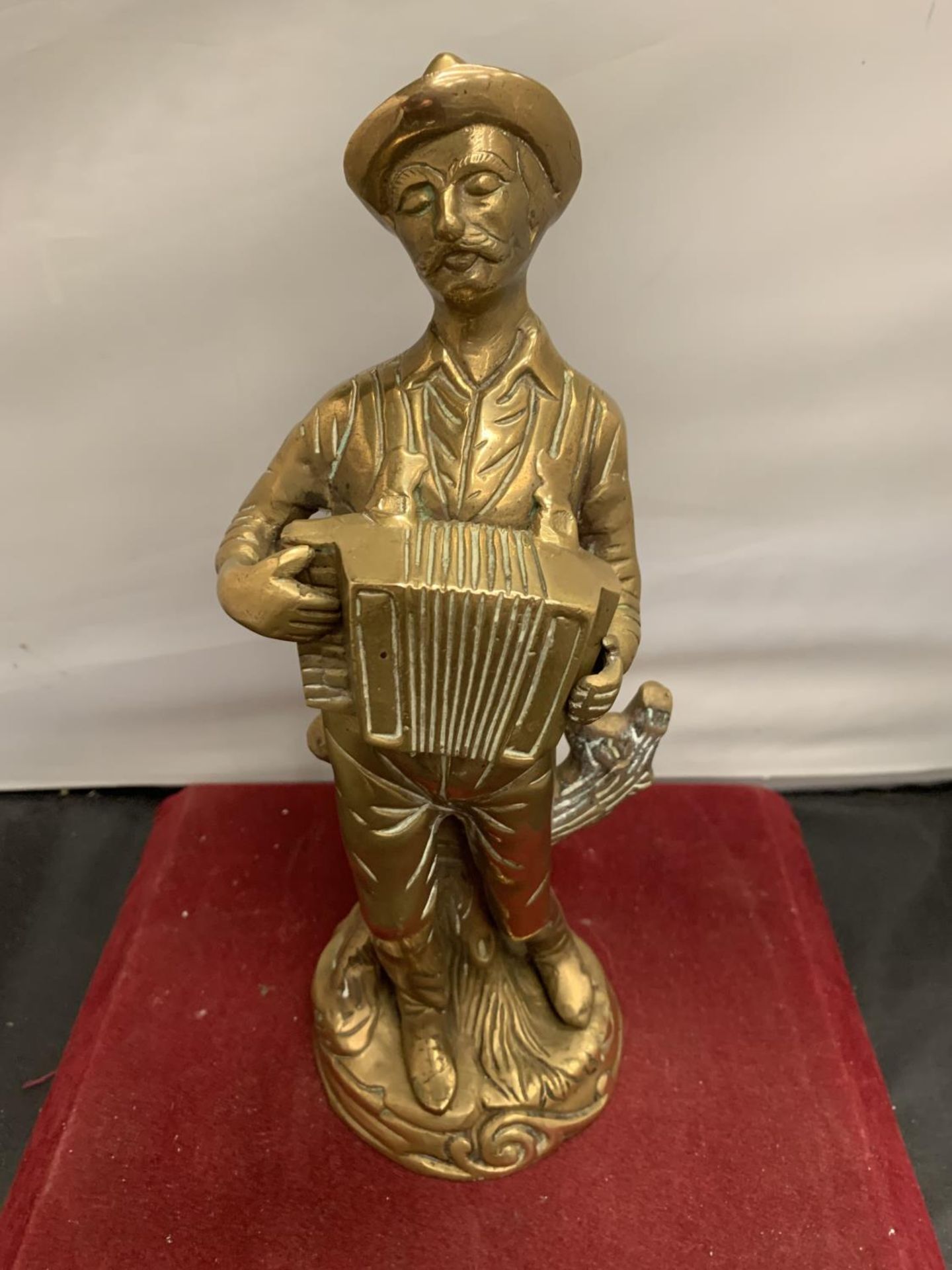 A BRASS FIGURINE IN THE FORM OF AN ACCORDIAN PLAYER H:28CM