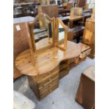A DUCAL PINE KIDNEY SHAPED DRESSING TABLE AND TWO PINE BEDSIDE CABINETS
