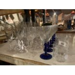 AN ASSORTMENT OF GLASSWARE TO INCLUDE BLUE STEMMED EXAMPLES
