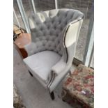 A RACHLIN CLASSICS HIGH BACKED WINGED EASY CHAIR WITH BUTTON BACK