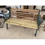 A WOODEN SLATTED GARDEN BENCH WITH CAST IRON BENCH ENDS