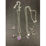 TWO SILVER NECKLACES WITH STAR AND TWIRL PENDANTS AND MATCHING EARRINGS