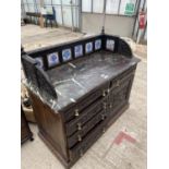 A VICTORIAN HEAVILY CARVED DARK OAK MARBLE TOPPED WASHSTAND WITH TILED GALLERY BACK, THE BASE