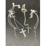 FOUR SILVER NECKLACES WITH CROSS PENDANTS TO INCLUDE CLEAR STONES