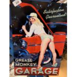 A TIN METAL 'GREASE MONKEY' GARAGE SIGN