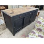 A LARGE VICTORIAN PINE SIDEBOARD WITH SCRUB TOP, SIX DRAWERS AND TWO SLIDING DOORS, 73" WIDE, 30"