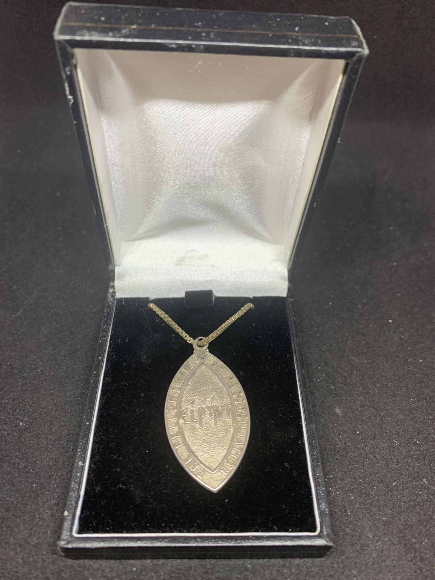 A SILVER NECKLACE WITH A FELLOWSHIP OF RECONCILIATION PENDANT IN A PRESENTATION BOX