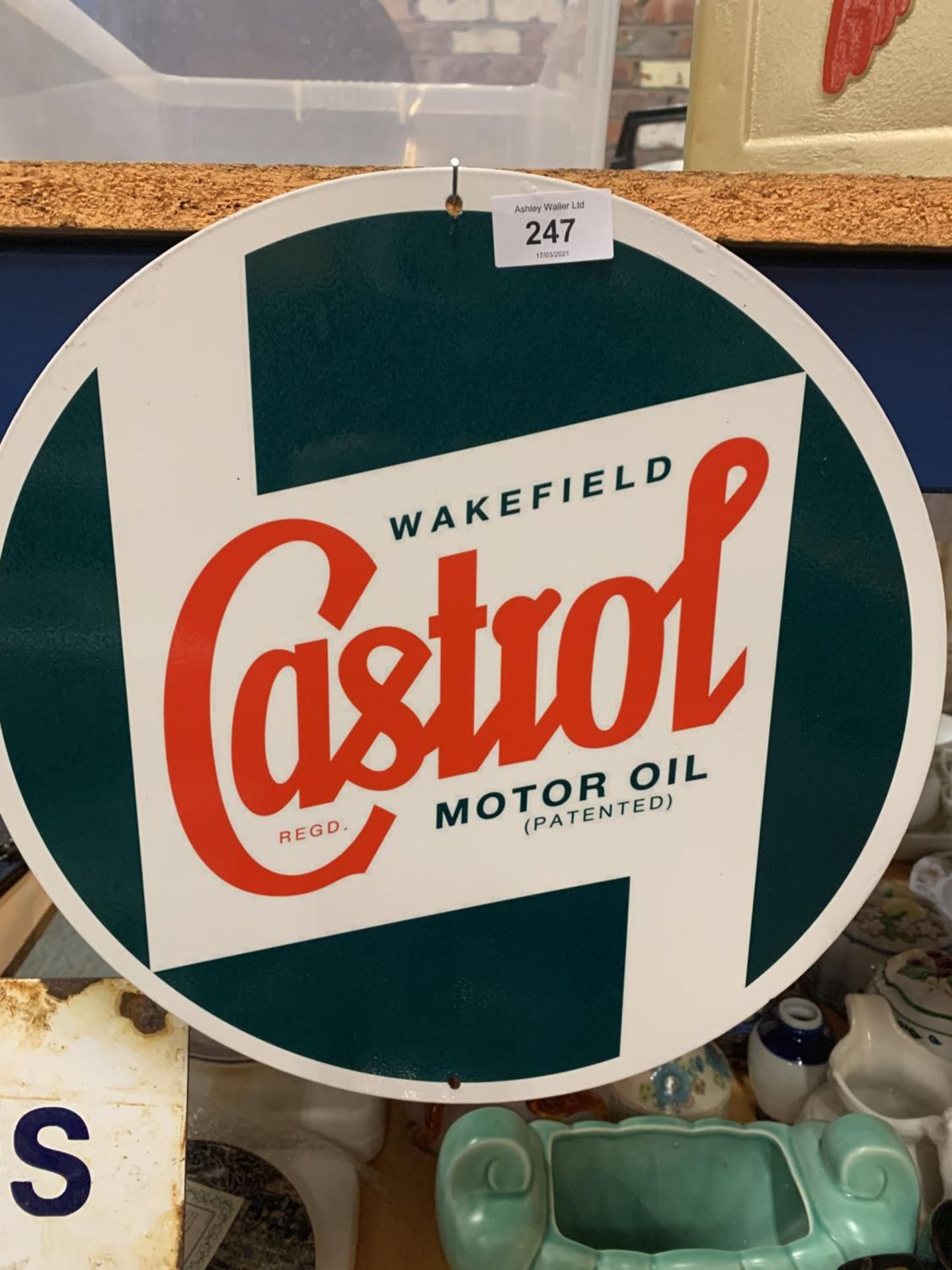 A ROUND METAL CASTROL SIGN