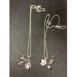 TWO SILVER NECKLACES WITH CLEAR STONE TWIST AND FLOWER PENDANTS AND MATCHING EARRINGS