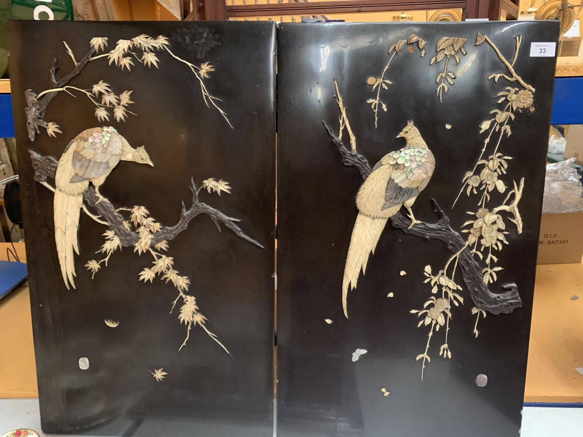 A PAIR OF CHINESE EBONISED WALL PLAQUES DEPICTING MOTHER OF PEARL BIRDS WITH ARTIST'S SIGNED STAMP