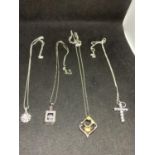 FOUR SILVER NECKLACES WITH CLEAR STONE PENDANTS TO INCLUDE A CROSS, FLOWER ETC
