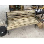 A WOODEN SLATTED GARDEN BENCH WITH CAST IRON BENCH ENDS