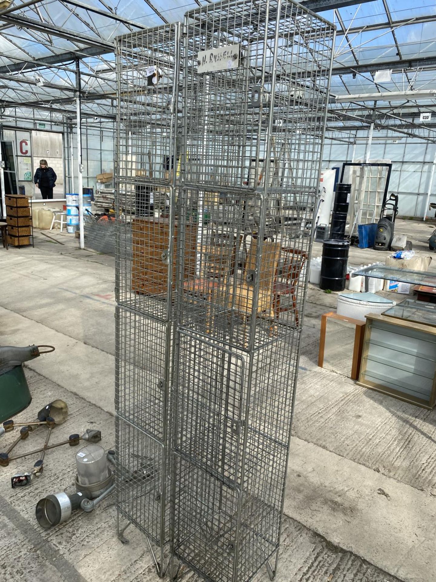 A PAIR OF FOUR SECTION METAL STORAGE CAGES