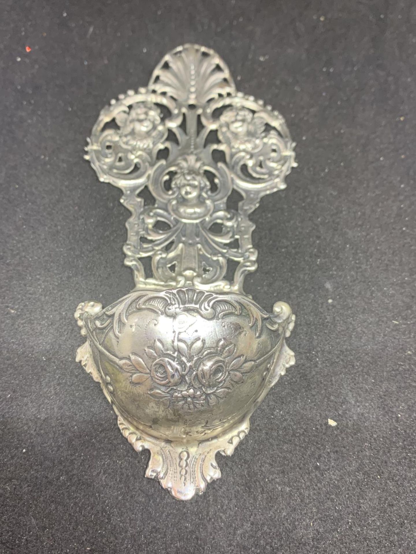 A CONTINENTAL SILVER HOLY WATER BOWL DEPICTING CHERUBS APPROXIMATELY 65 GRAMS H:15CM