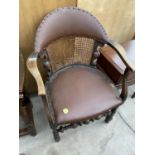 AN EARLY 20TH CENTURY JACOBEAN STYLE ELBOW CHAIR WITH SPLIT CANE BACK A/F