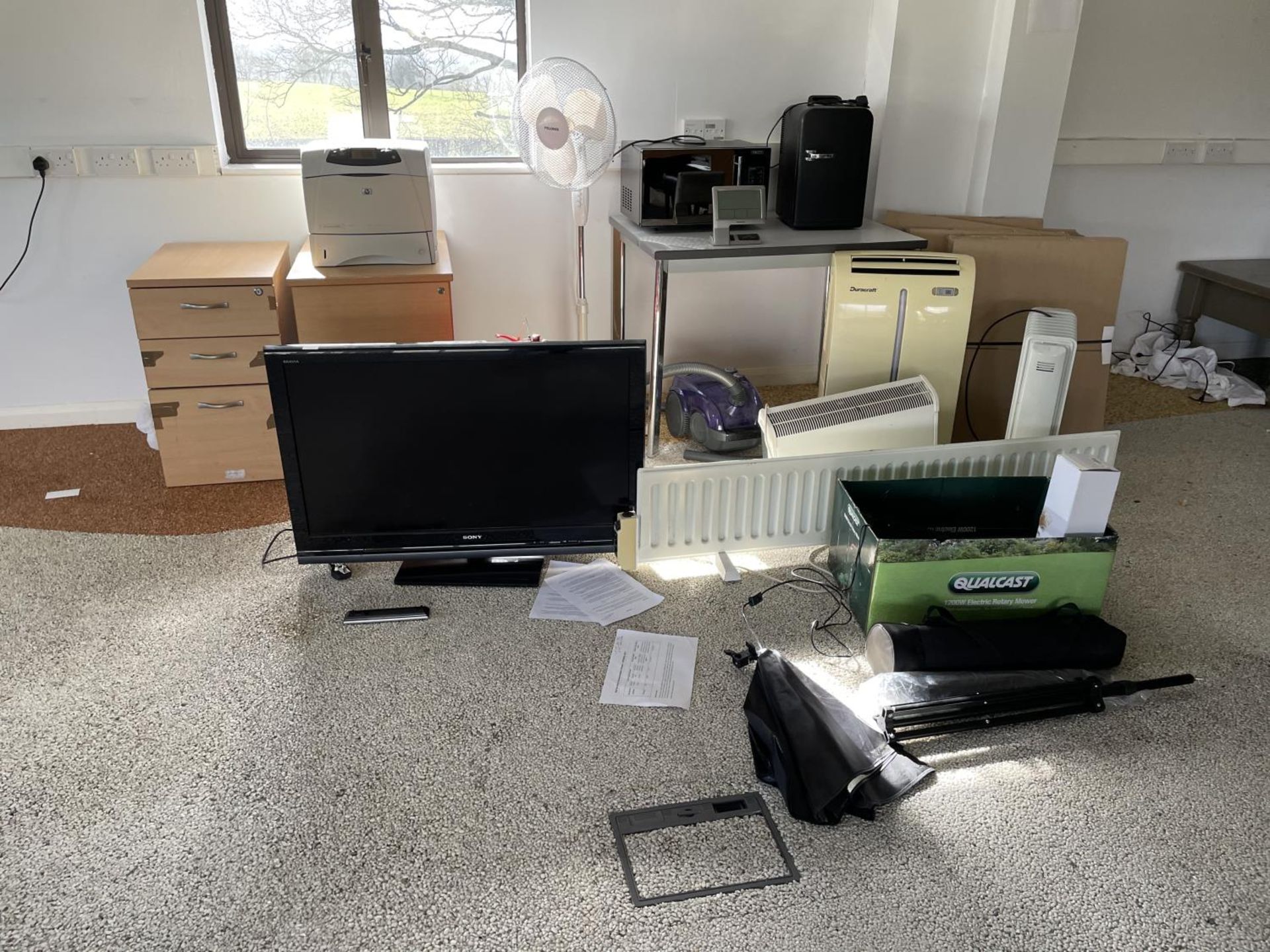 AN ASSORTMENT OF OFFICE ITEMS TO INCLUDE A TELEVISION, A MICROWAVE, HEATERS AND PACKING EQUIPMENT