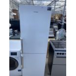 A WHITE SAMSUNG UPRIGHT FRIDGE FREEZER BELIEVED WORKING BUT NO WARRANTY