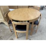 A MODERN CIRCULAR (41.5" DIAMETER) KITCHEN DINING TABLE AND FOUR INTEGRAL CHAIRS