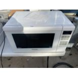 A WHITE PANASONIC MICROWAVE OVEN BELIEVED IN WORKING ORDER BUT NO WARRANTY