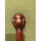 A FOUR FACED BUDDHA TOPPED WALKING STICK