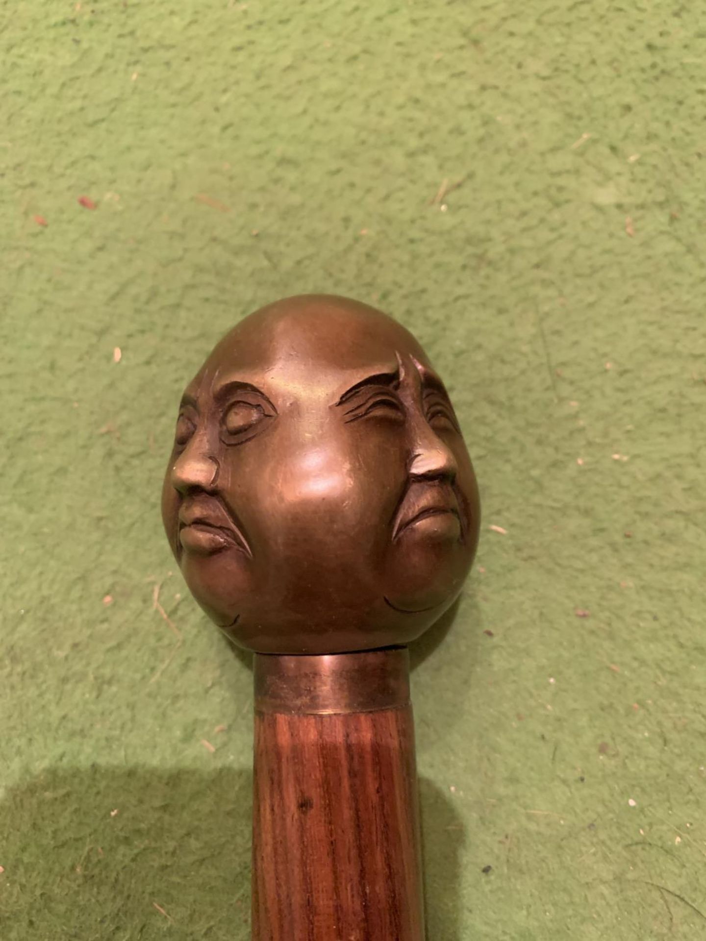 A FOUR FACED BUDDHA TOPPED WALKING STICK