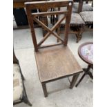 A VICTORIAN OAK KITCHEN CHAIR WITH SOLID SEAT AND X FRAME BACK